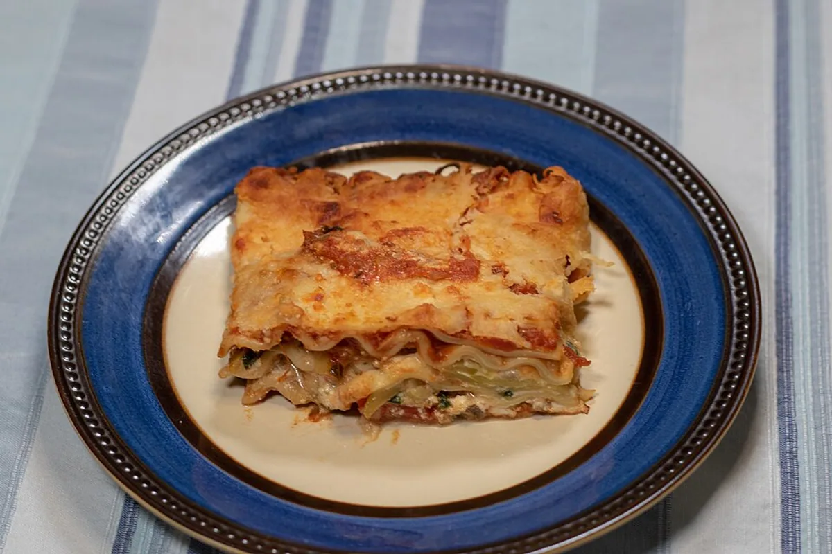 Plated slice of vegetarian eggplant lasagna with melted cheese