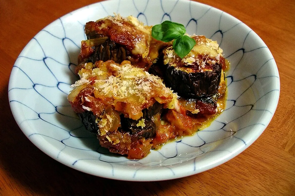 Breaded eggplant Parmesan with tomato sauce melted cheese and basil