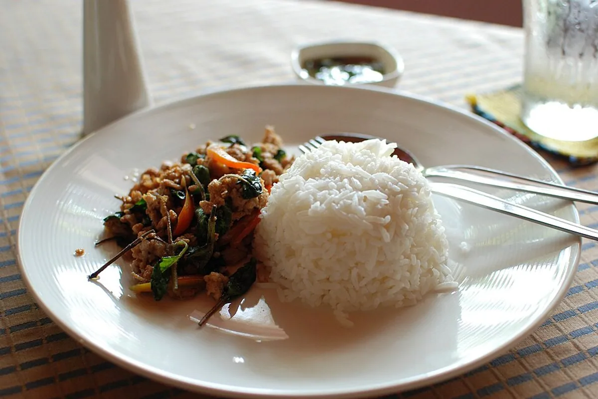 Thai basil pork with chiles and basil beside white rice