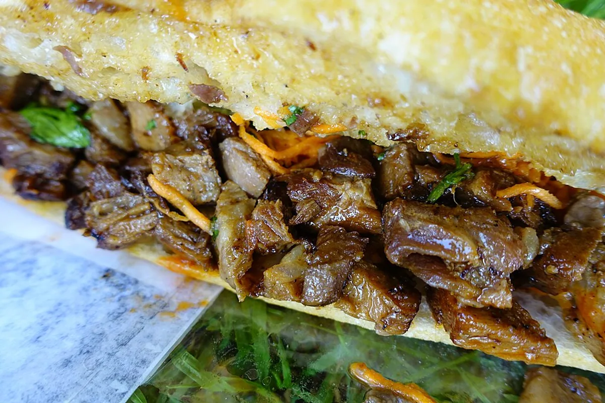 Close-up of pork banh mi sandwich in a crisp baguette
