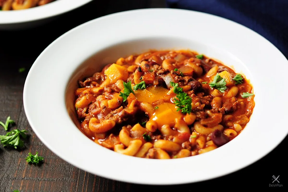 Bowl of one-pot turkey chili mac with beans and herbs